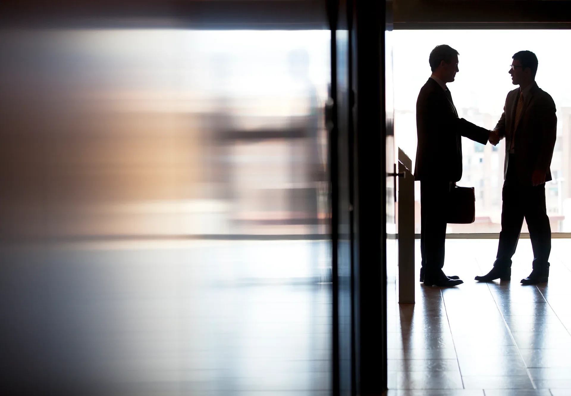 An agent greeting a client in person — the channels that work without a feed are the ones that put you in the room