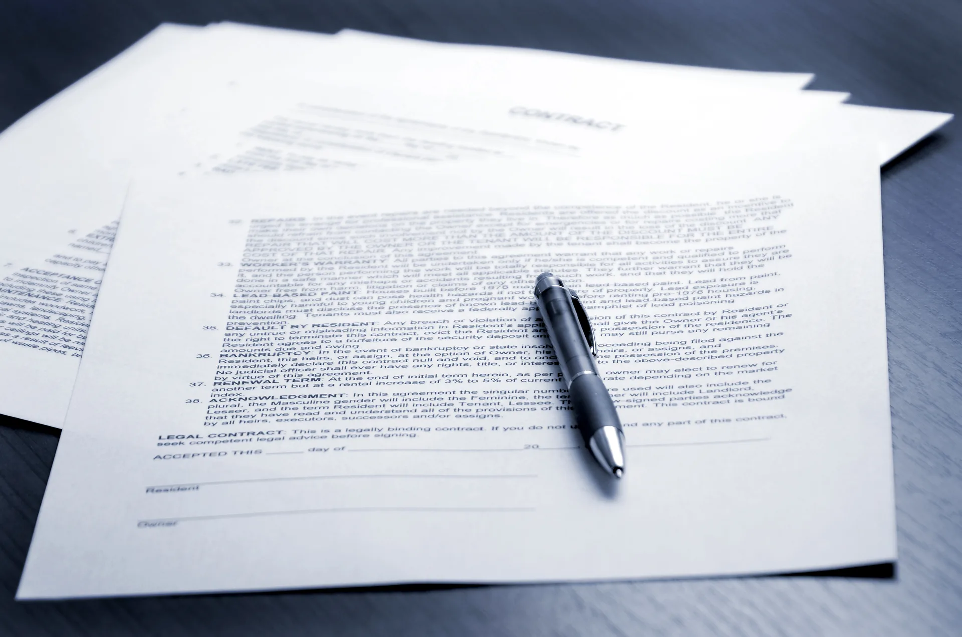 A contract being signed — MLS data reaches a website through paperwork before plumbing