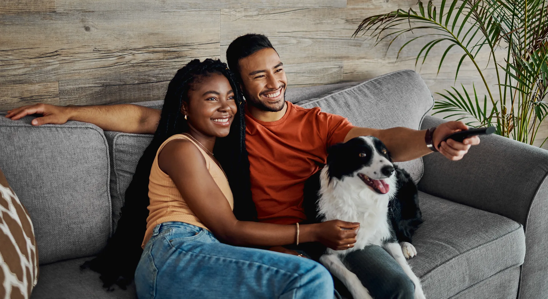 A couple at home on the sofa reviewing their saved homes together