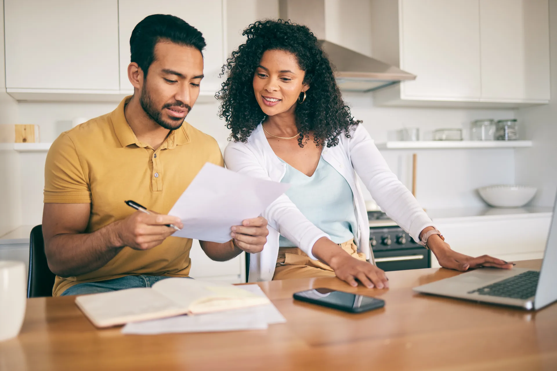 A couple working through mortgage paperwork and payment math
