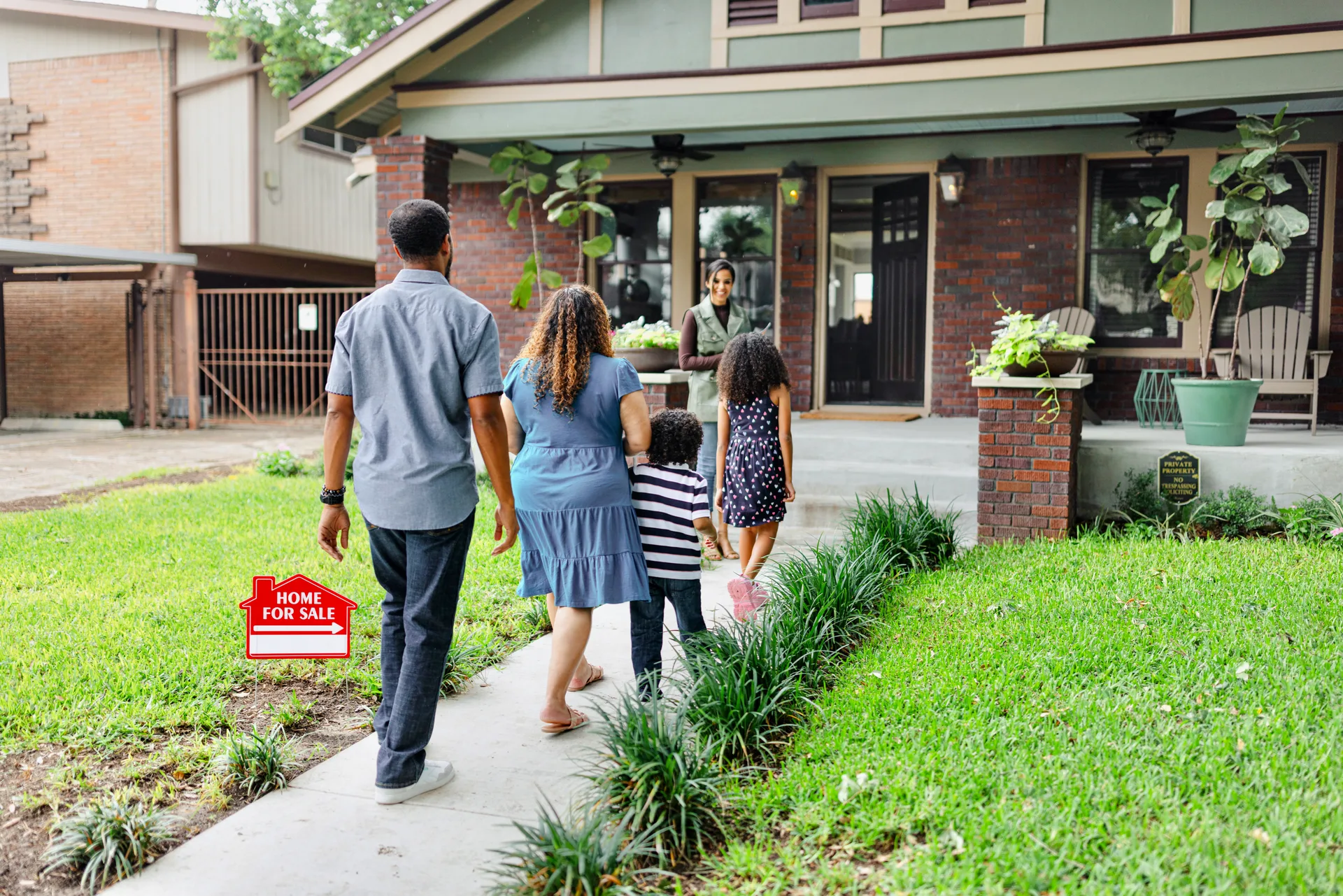 An agent walking a young family through a home tour — the showing a long-nurtured lead finally books