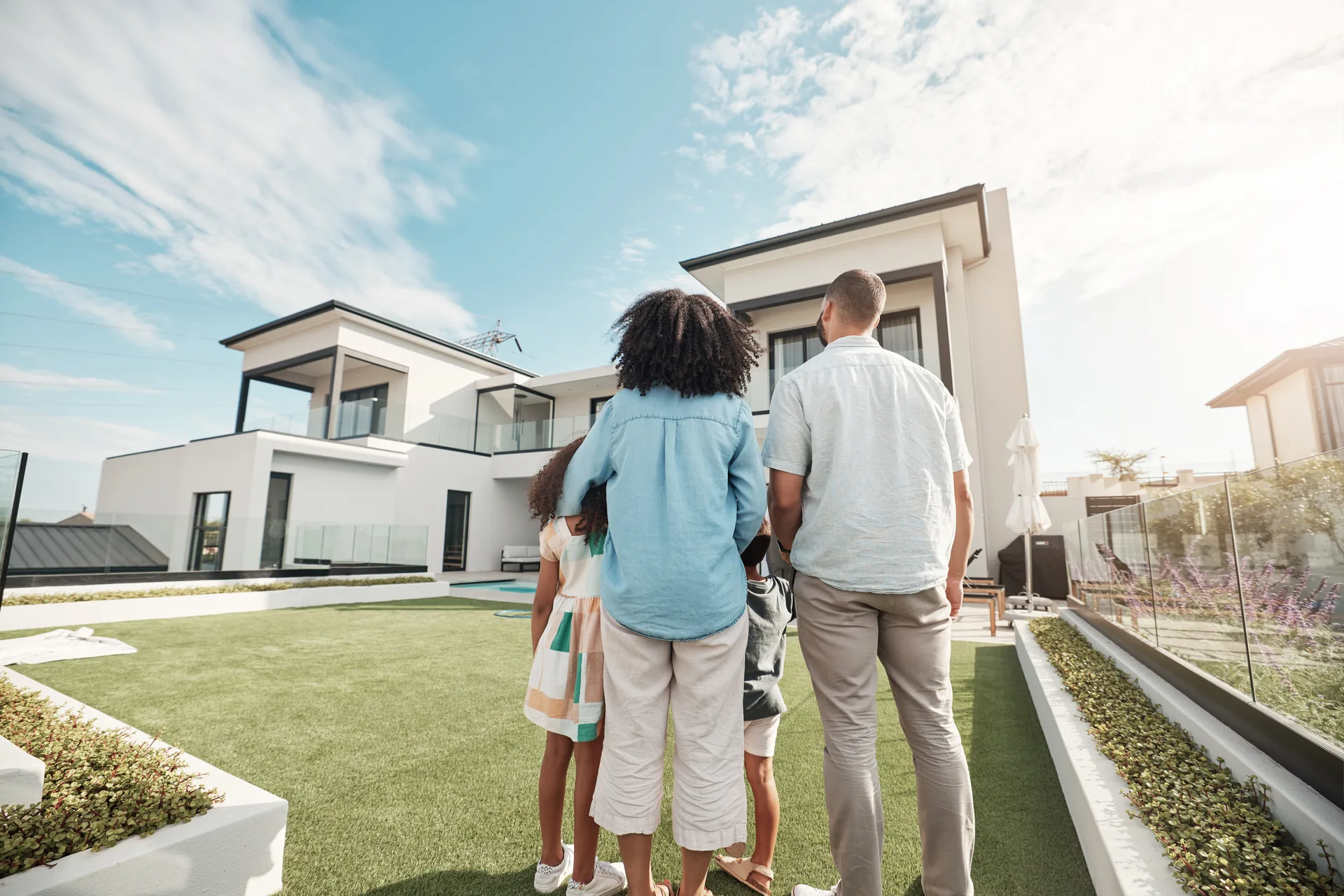 A family in the backyard of a home they hope to buy