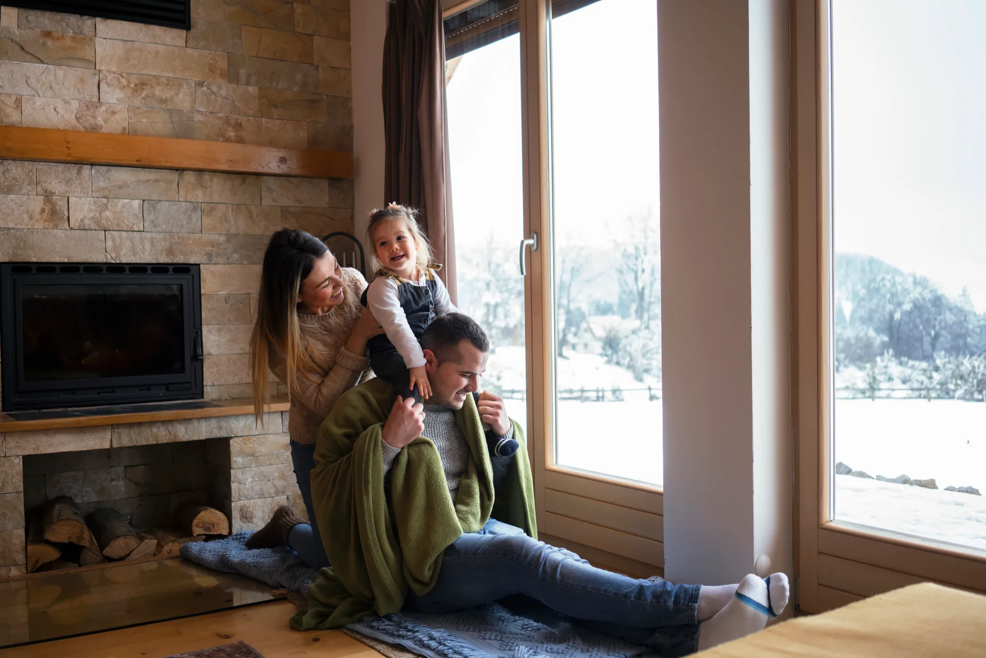 A family together at a bright window on a winter day, at home in a true four-season northern city