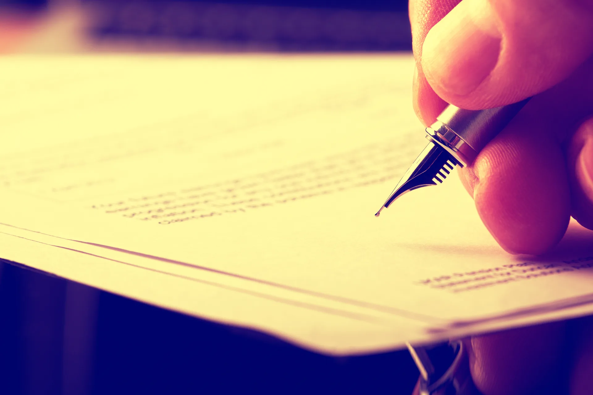 Signature being written with a fountain pen — express consent is a recorded act, not an assumption