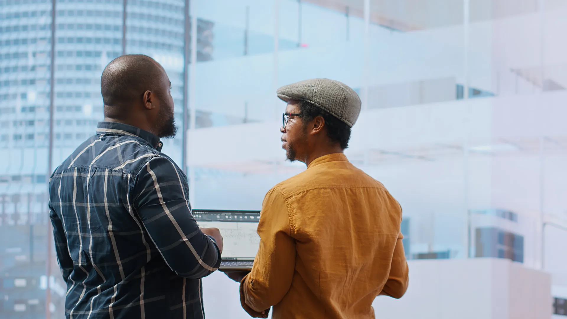 A small real estate team standing together in an office