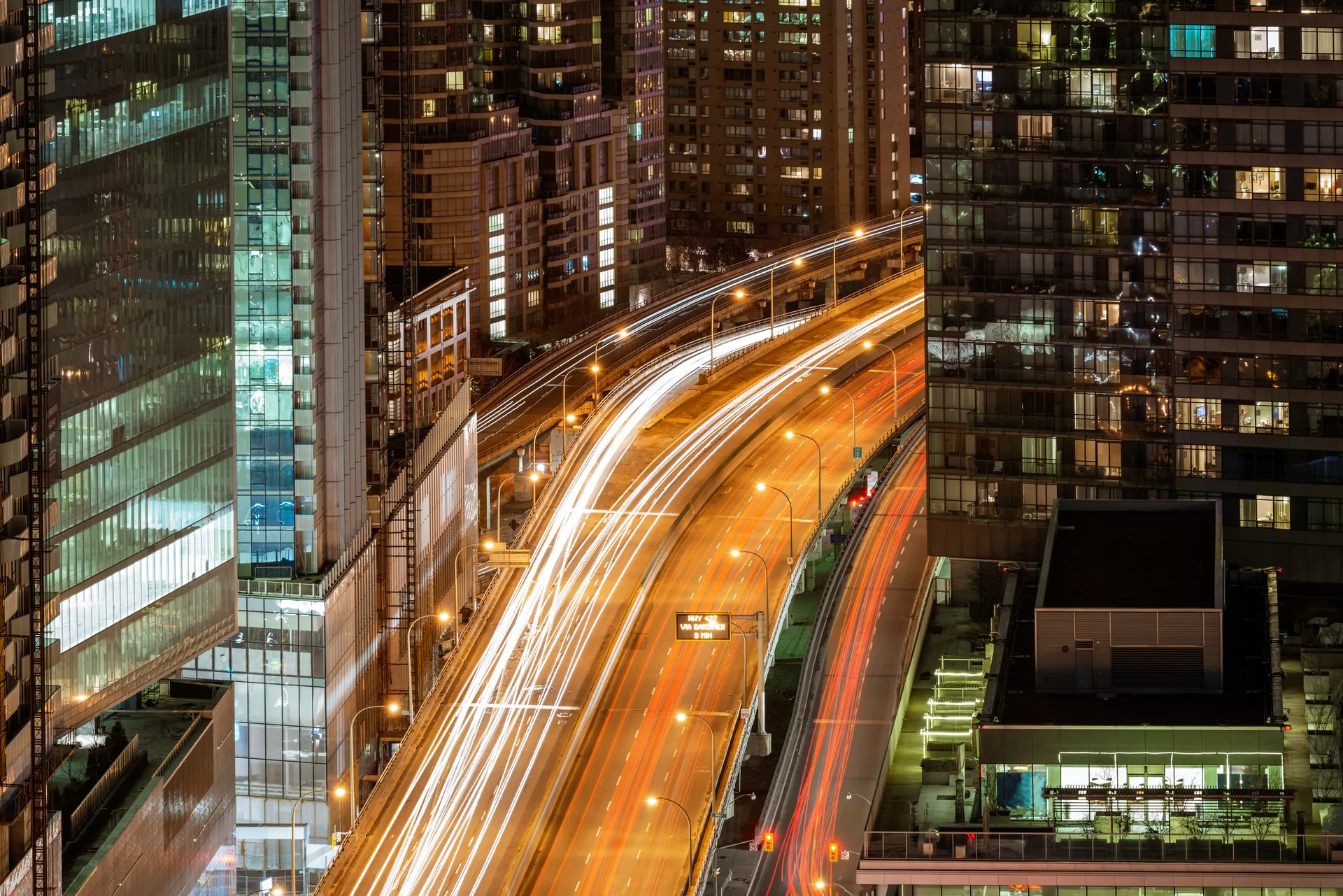 Toronto traffic and towers after dark — the loudest real estate marketing arena in the country