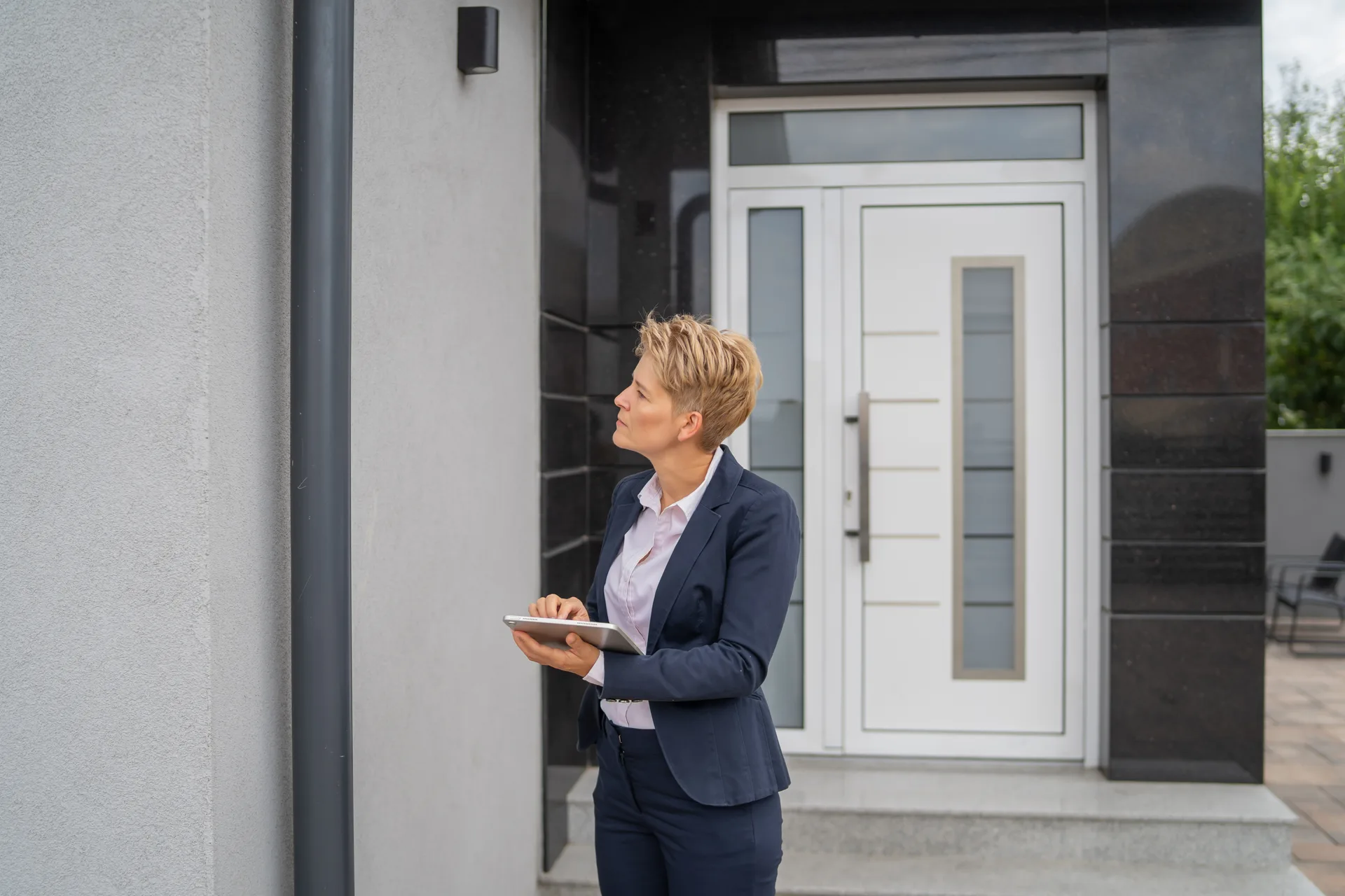 A professional assessing a property in person — the walkthrough behind a real CMA