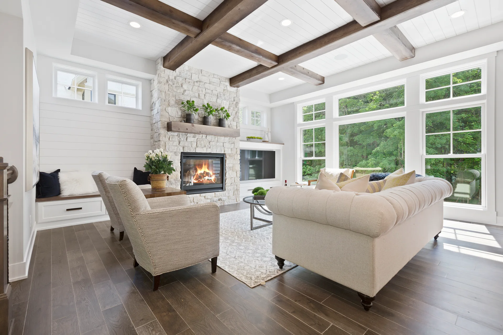 A bright family room with big windows onto trees, the comfortable detached living a northern lake city offers