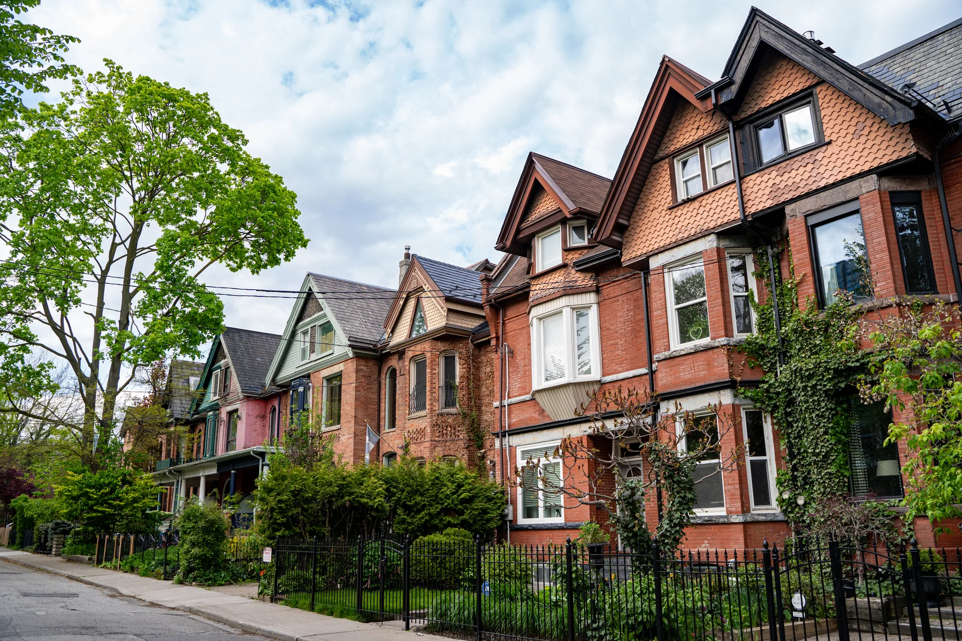 Victorian semi-detached homes on a Toronto street — the neighbourhood-scale searches where a Toronto agent can actually rank