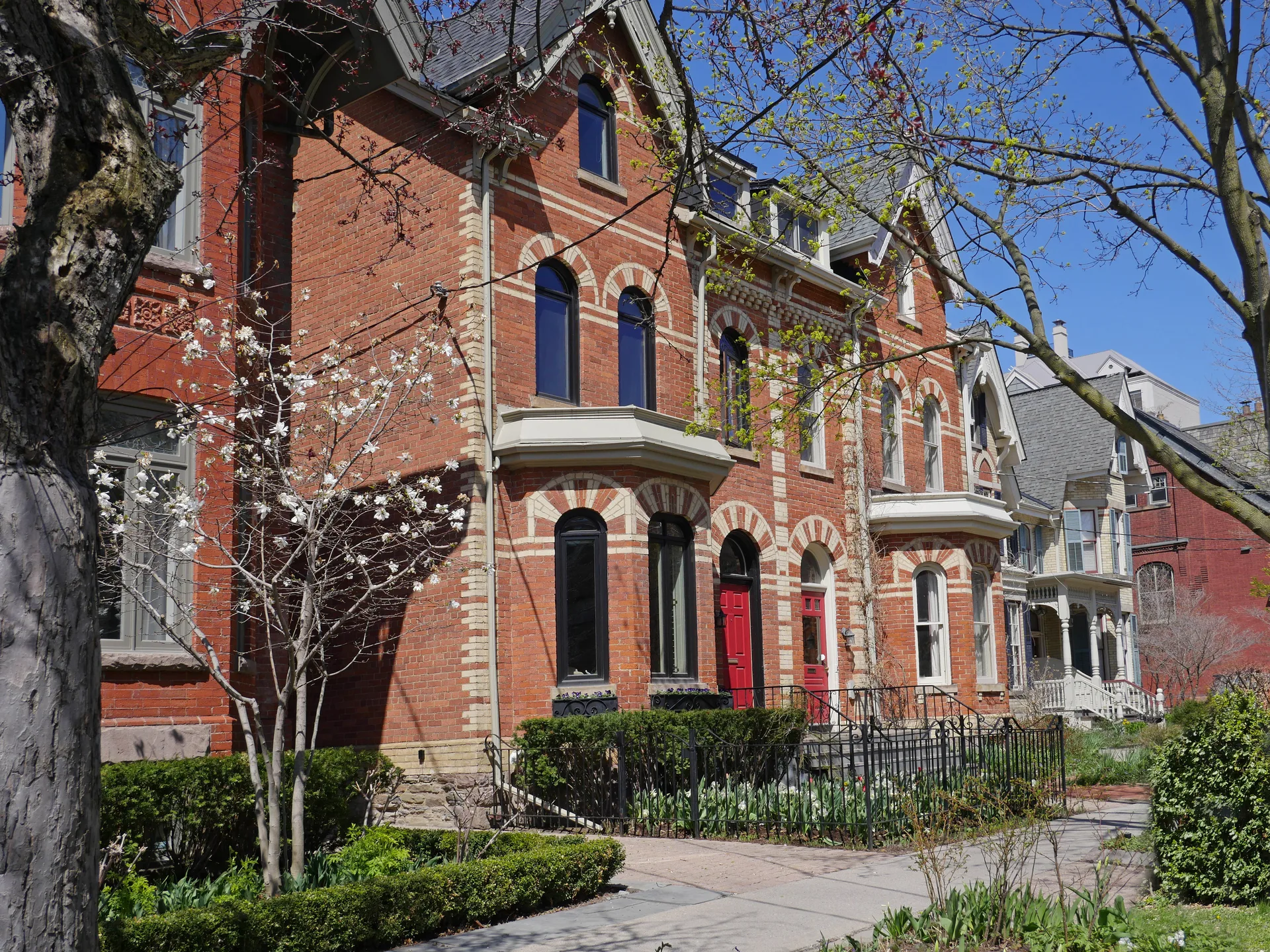 Older brick homes on a mature tree-lined street, the housing stock a riverfront value market is built on