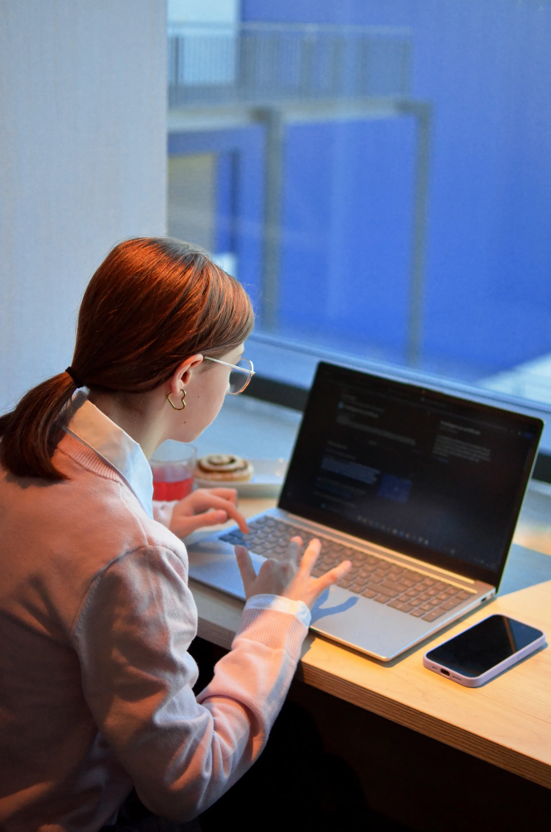 A laptop mid-build in an office — the generated layer of a website is the easy layer