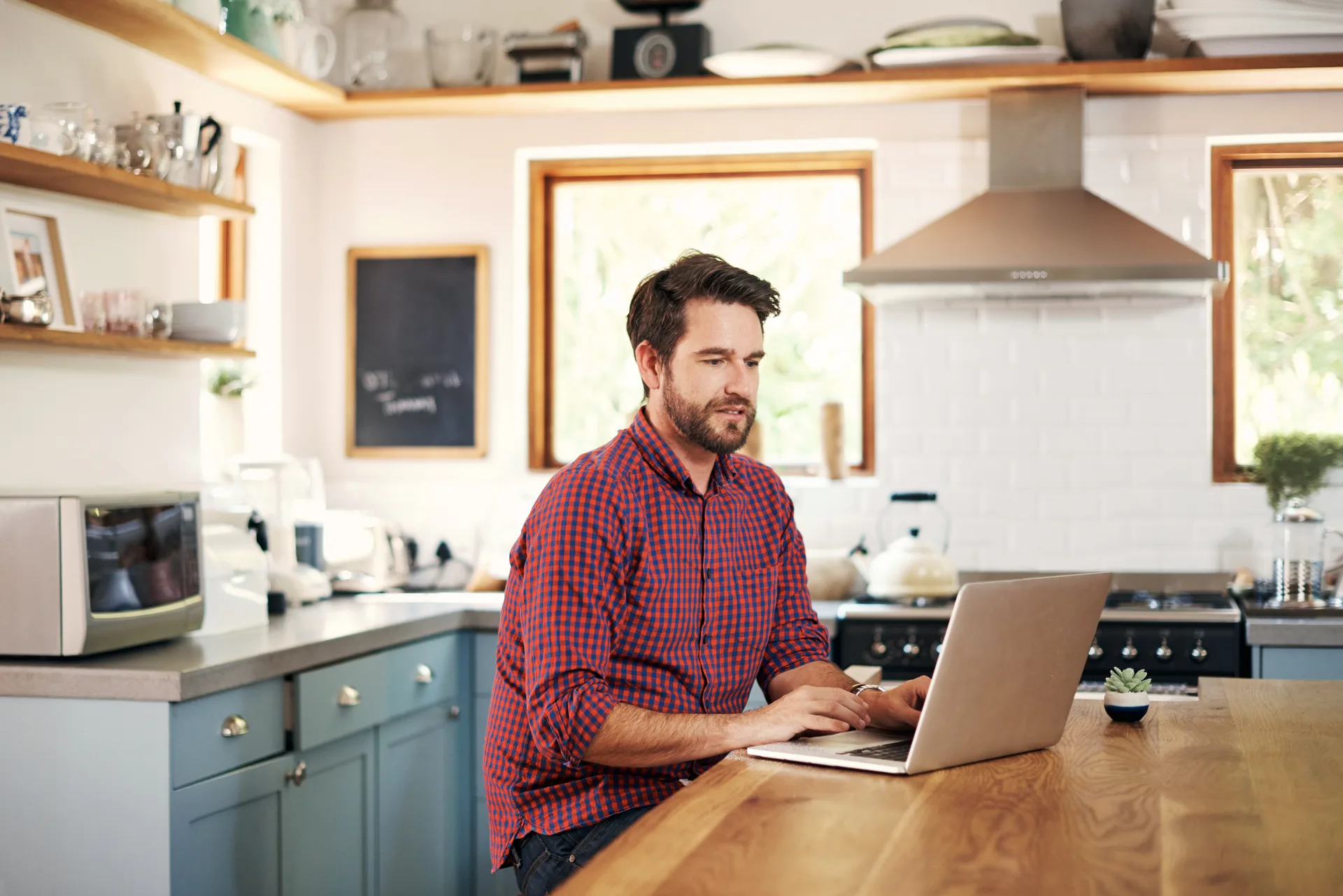 A laptop open on the kitchen counter for a two-minute pipeline check