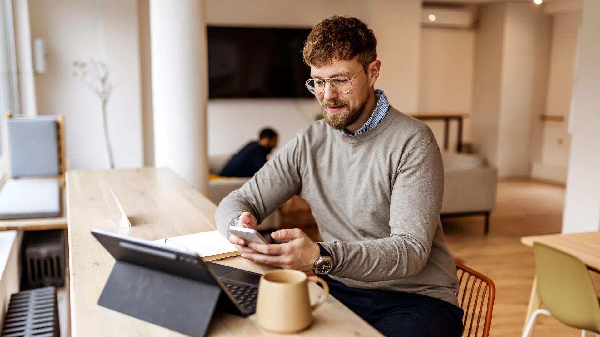 Laptop and phone side by side — capture on one screen, the instant notification on the other