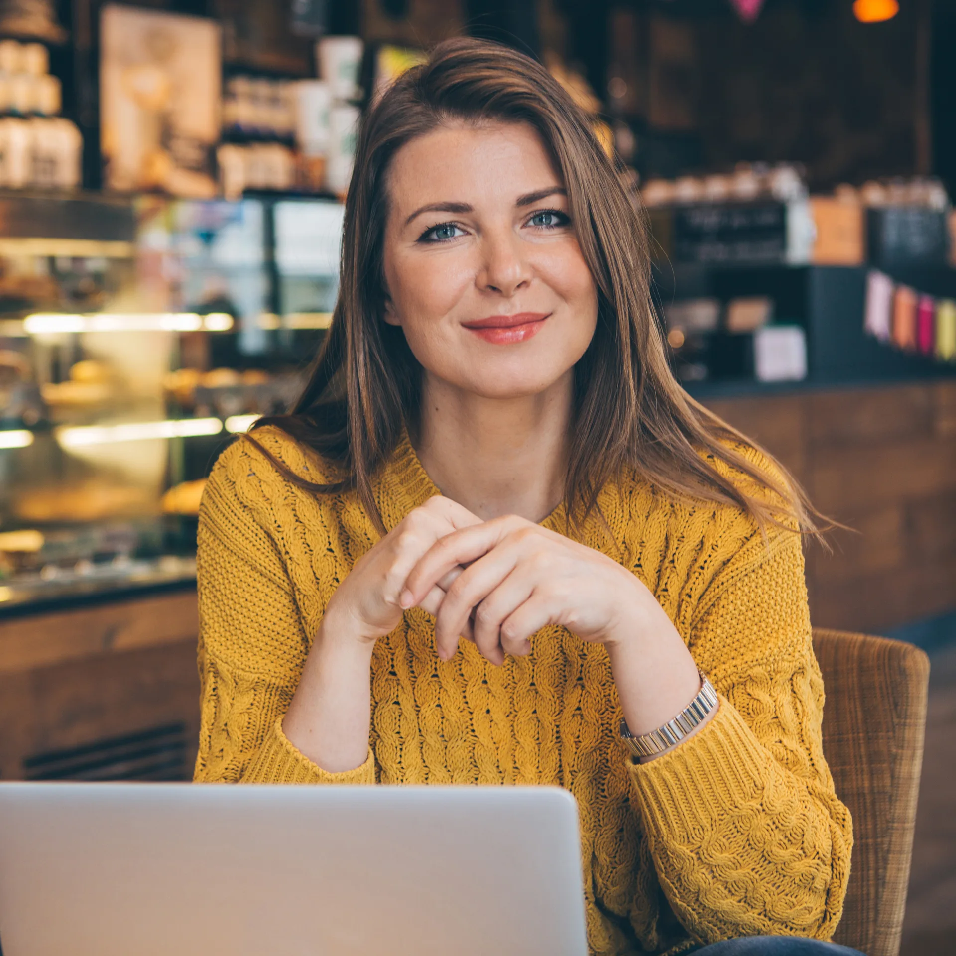 Composing an email once from a café table — automation carries it to the rest of the list