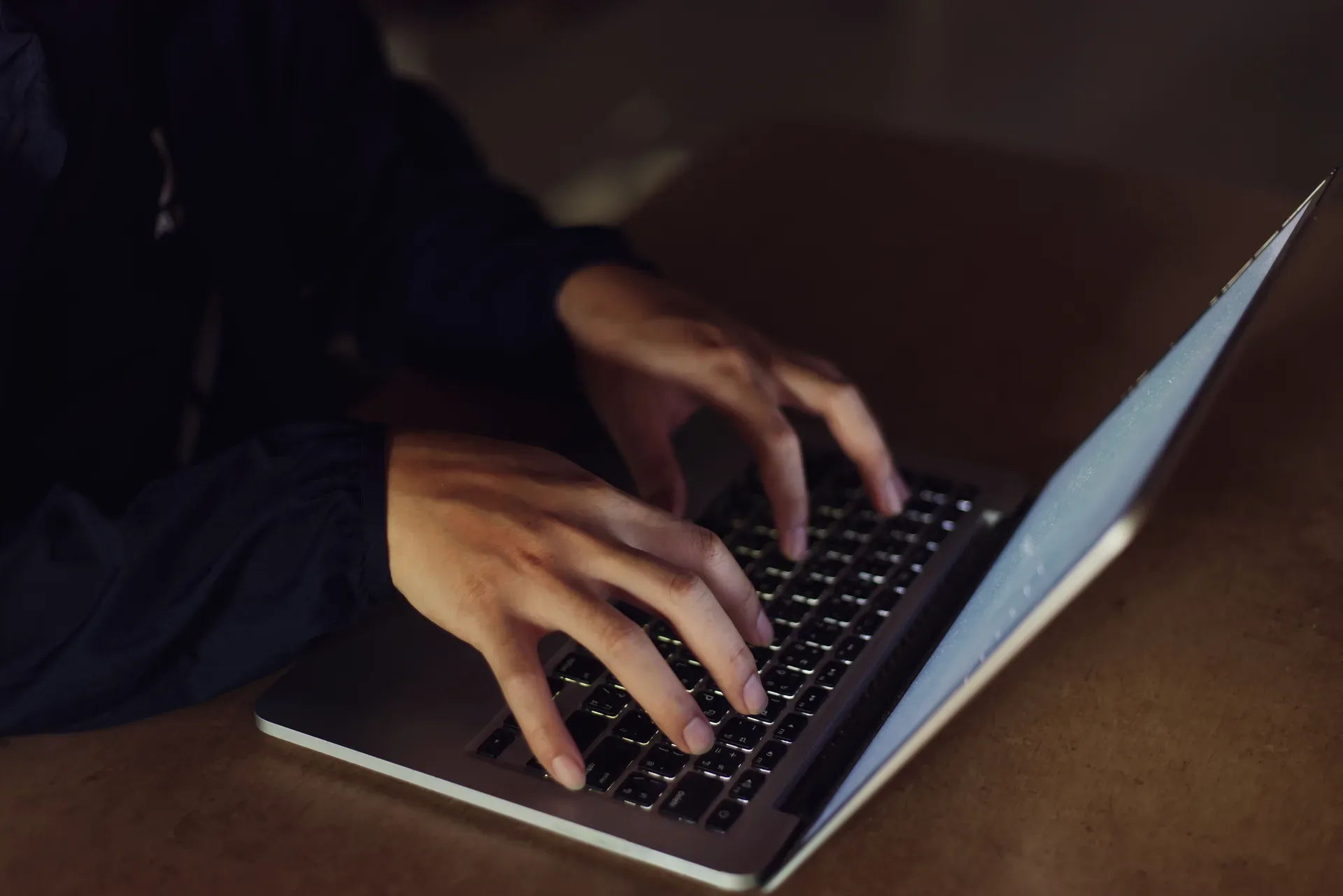Hands at a keyboard managing a self-hosted site — with WordPress, the operator role is yours