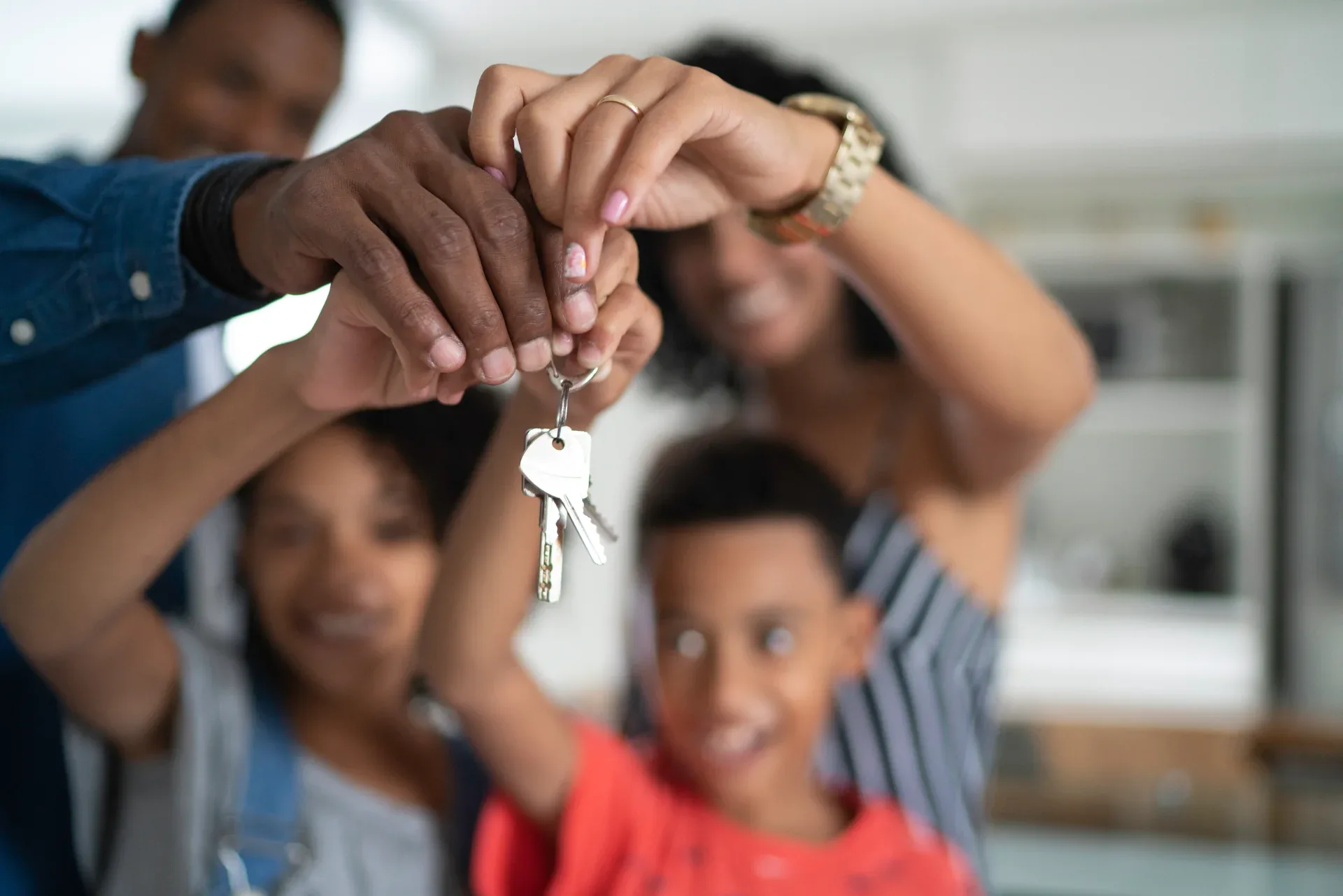 A family holding the keys to their new home