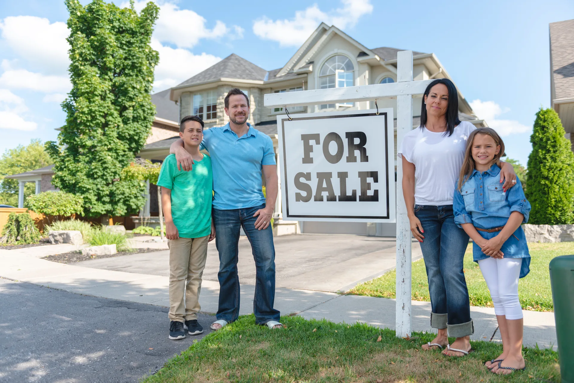 A family outside a home listed for sale — the pricing question sold comparables answer