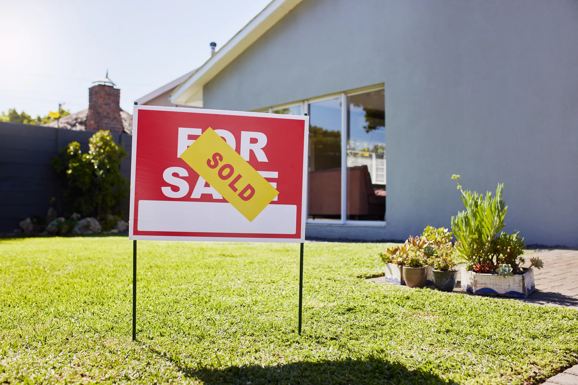 A sold sticker across a for-sale sign — the moment agents most want to advertise