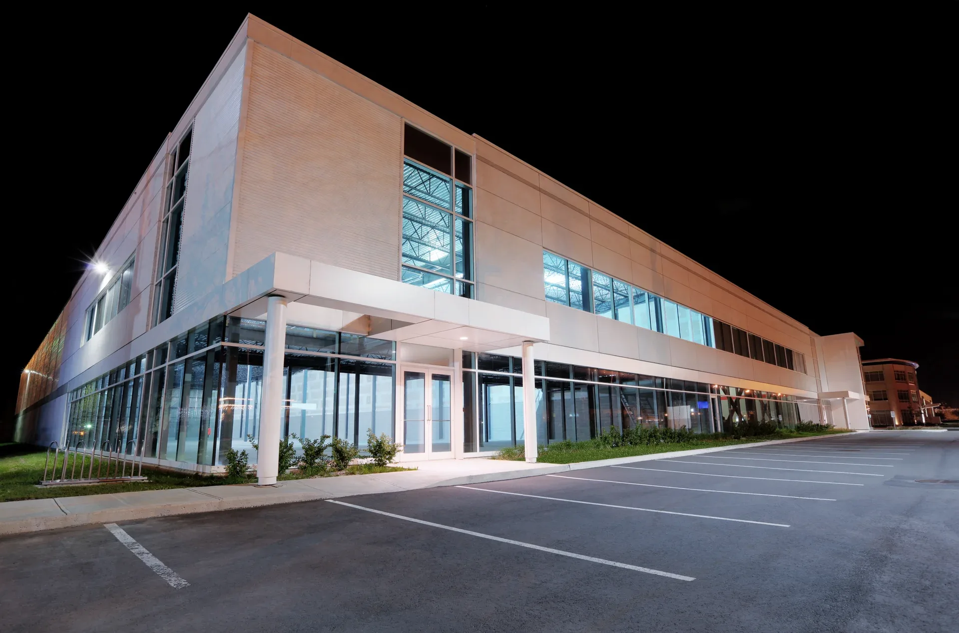 Downtown towers lit at night — board data systems replicate around the clock