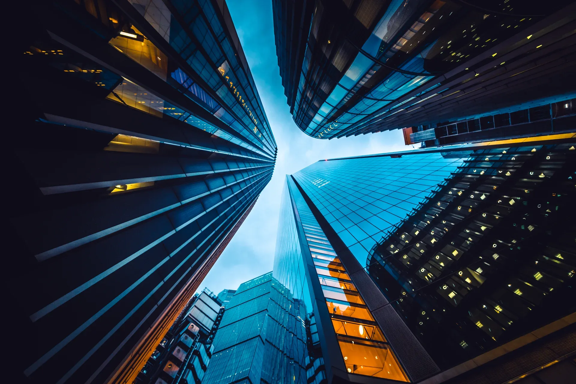 Office towers seen from street level — the corporate layer that licenses a board's listing data